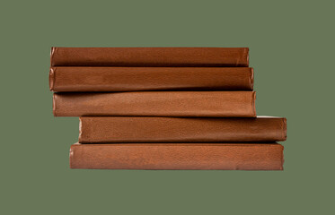 Book stack. Brown same literature pile in brown hardback on green background. High quality photo