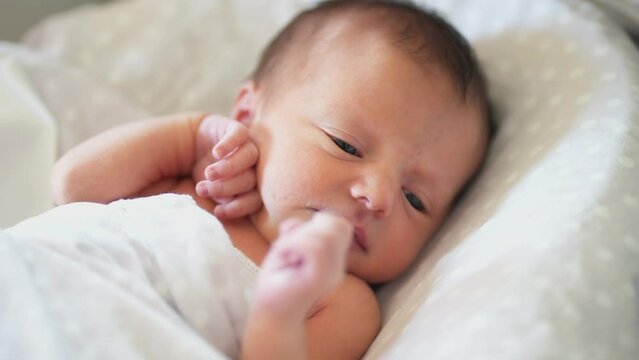 baby newborn. little baby a newborn 1 month of life lies in bed in the maternity hospital. happy family kid dream concept. lifestyle close-up baby indoors. beautiful cute girl lies at home