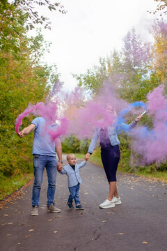 Little Boy With Parents On Gender Party With Colorful Smoke