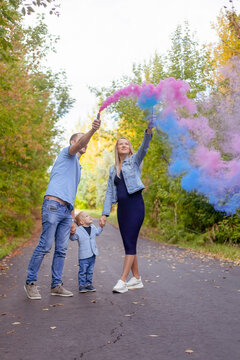 Little Boy With Parents On Gender Party With Colorful Smoke