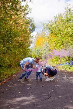 Little Boy With Parents On Gender Party With Colorful Smoke