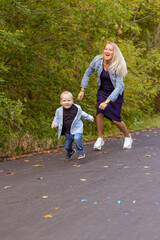 little boy running in the park with mom
