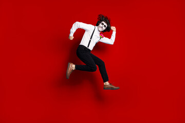 Fototapeta na wymiar Full length body size view of his he handsome funky comic childish cheerful cheery gentleman jumping having fun running fooling calavera fest isolated bright vivid shine vibrant red color background