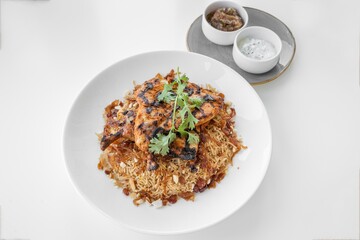 Smoked Chicken biryani served in a dish isolated on grey background side view