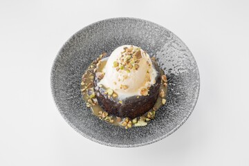 Sticky Toffee Pudding served in a dish isolated on grey background side view