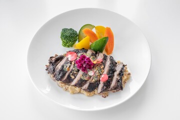 Tenderloin Steak with salad served in a dish isolated on grey background side view