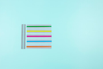 Dyslexia. Top view to colorful reading highlight bookmark overlay strips on light blue background....