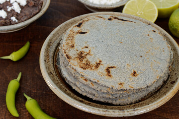 Homemade blue corn tortillas in a pile on a table. Mexican traditional cuisine bread.
