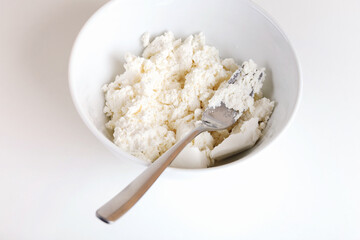 Photographic Recipe of Ukrainian Cottage Cheese Pancakes, Also Known as Syrnyky. Step 1: Mesh 250 Grams of Cottage Cheese.