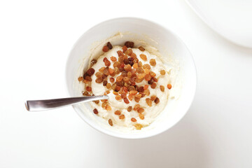 Photographic Recipe of Ukrainian Cottage Cheese Pancakes, Also Known as Syrnyky. Step 4: Add Some Raisins, Stir, Mold Pancakes, Dust With Flour and Fry in a Pan.