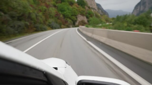 POV of a car driving along a Georgian highway. The concept of vehicles and drivers. No people.
