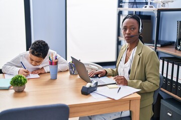 Young mother wearing call center agent headset thinking attitude and sober expression looking self confident