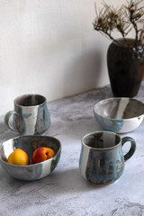 Pottery made of clay. Handmade cups and mugs.