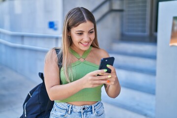Young beautiful hispanic woman student smiling confident using smartphone at university