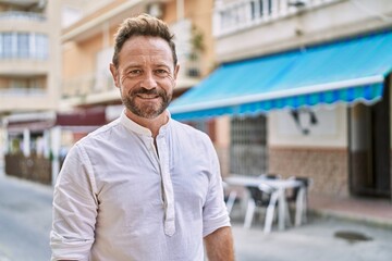 Middle age man smiling confident at the city