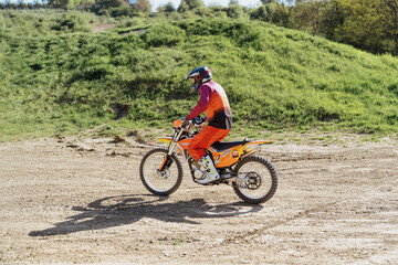 Obraz premium Extreme and Adrenaline. Motocross rider in action. Motocross sport. Active lifestyle.