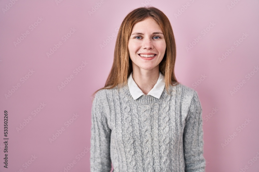 Poster beautiful woman standing over pink background with a happy and cool smile on face. lucky person.