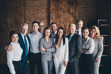 Portrait of group successful positive people hug standing together building indoors