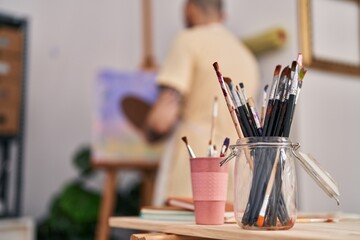 Young bald man artist drawing at art studio