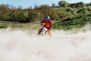 Extreme and Adrenaline. Motocross rider in action. Motocross sport. Active lifestyle. Flying dust.