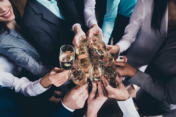 Cropped view portrait of attractive cheerful people employers gathering celebrating festive clinking glasses