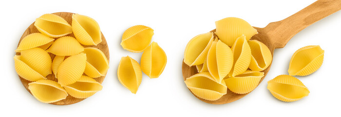 Uncooked dried conchiglie in spoon. Raw shell pasta isolated on white bachground with full depth of field. Top view. Flat lay