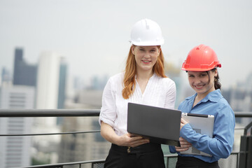 A portrait of an industrial man and woman engineer with tablet in a factory, working. Engineer Working on Computer, Project Manager, Another Specialist Joins Discussion. Team of Professionals.