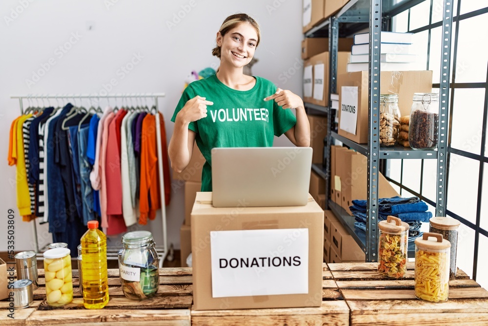 Sticker young blonde woman wearing volunteer t shirt at donations stand looking confident with smile on face