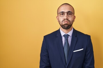 Hispanic man with beard wearing suit and tie puffing cheeks with funny face. mouth inflated with air, crazy expression. - obrazy, fototapety, plakaty
