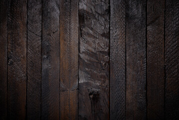 Dark stained rough wooden planks texture background