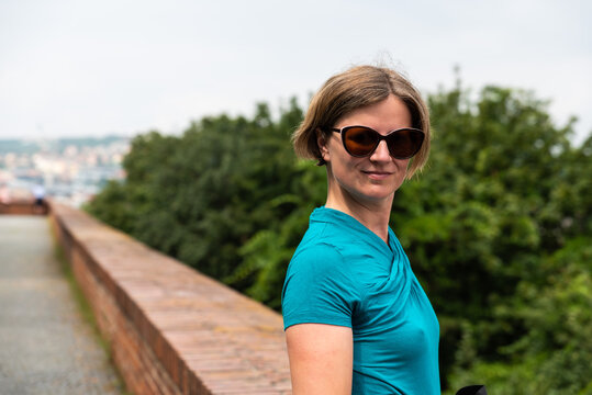Portrait of an attractive thirty year old woman with sunglasses posing outdoors