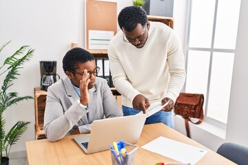 Man and woman business workers using laptop working at office