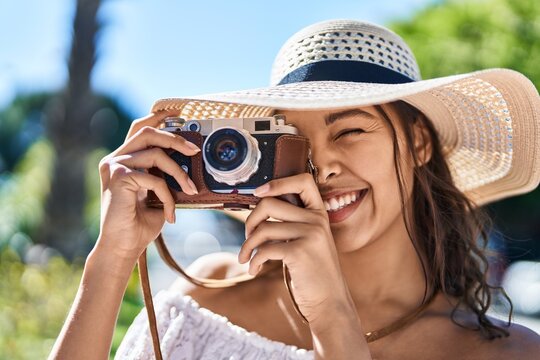 Young african american woman tourist smiling confident using camera at park