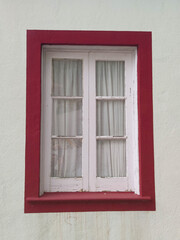 colorful window on a white wall with colorfuls strokes, at flores island at the azores portugal