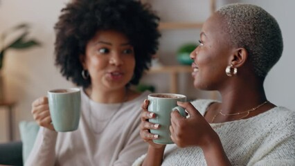 Friends relax and women talk with hot chocolate drink as they enjoy discussion together. Happy girl friendship, conversation and cheers while speaking of positive development in apartment.