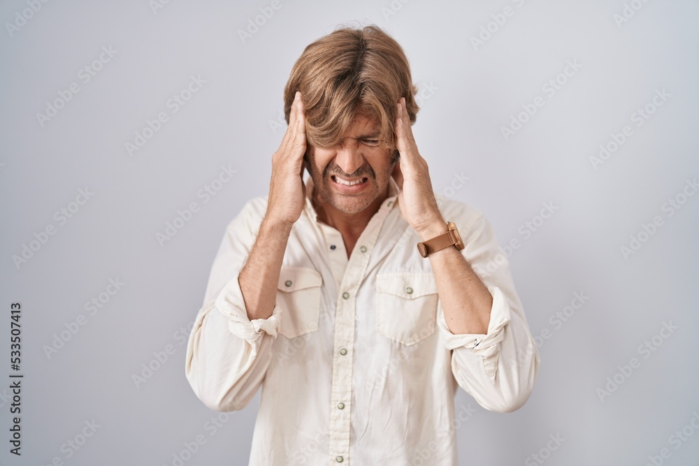 Sticker Middle age man standing over isolated background with hand on head, headache because stress. suffering migraine.