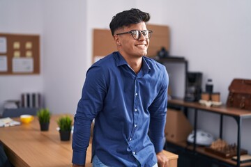 Young hispanic man business worker smiling confident at office