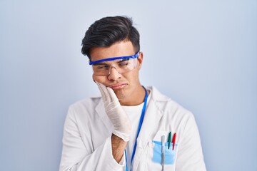 Hispanic man working as scientist thinking looking tired and bored with depression problems with crossed arms.