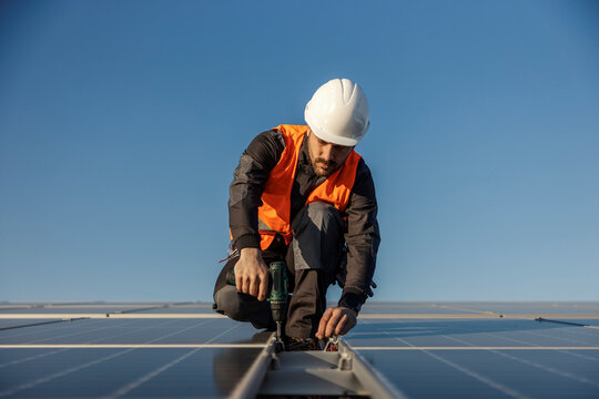A worker is installing solar panels.