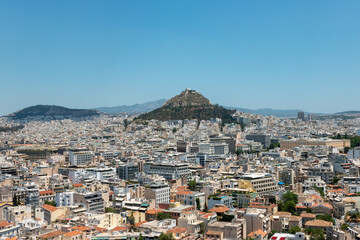 Fototapeta na wymiar Lycabettus Hill, Athens and the surrounding rooftops of the city.
