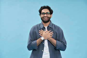 Grateful pleased proud happy arab young man holding hands on chest, thanking, feeling gratitude,...