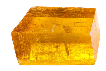 Transparent yellow optical calcite Iceland spar stone on white surface