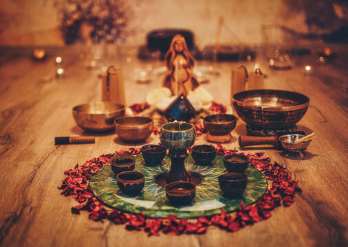 Beautiful altar with rose petals and goddess statuette. ceremony space.