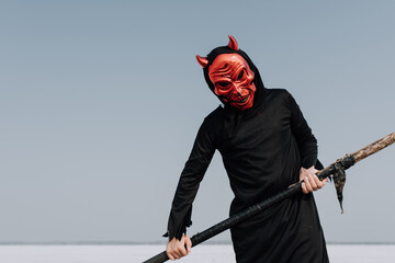 Teen wearing scary Halloween costume in the desolate landscape of the Great Salt Plains 