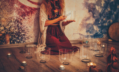 soundhealing, beautiful woman playing crystal bowls on cacao ceremony.