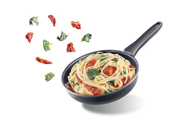 Dried tomato spinach Pasta in a pan on a white isolated background
