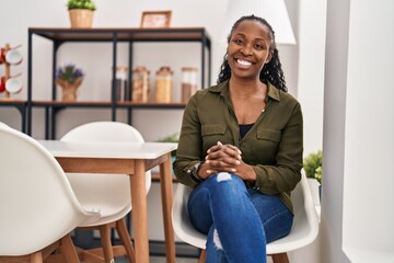 African american woman smiling confident sitting on chair at home