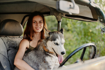 Woman and her husky dog happily traveling in car smile with teeth autumn walk with pet, travel with dog friend
