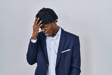 Young african man with dreadlocks wearing business jacket over white background with sad expression covering face with hands while crying. depression concept.