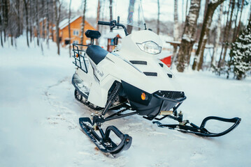 snowmobile covered with snow in winter on a cold day